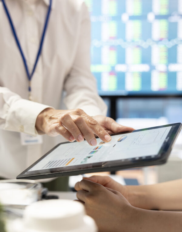 CEO leading a corporate briefing meeting to present monthly statistics, reviewing economic forecasts and discussing enterprise solutions. Staff setting strategic priorities for development. Close up.